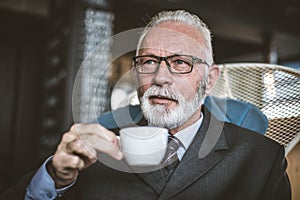 Senor businessman drinking coffee. Relax time. photo