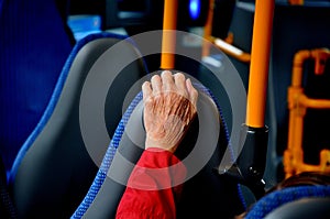 Senor female citizen hand during bus journey in Copenhagen