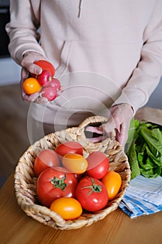 Senora woman holding a basket with farm tomatoes
