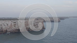 Sensational aerial drone view of Portugal beauty rocky cliff coast in Lagos Algarve, circle pan, cloudy day