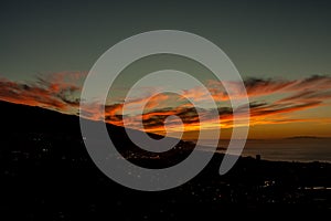 Sensational sunset behind the mountain with cloud formations