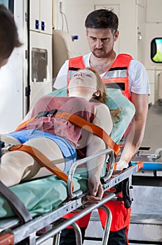 Senseless girl lying on stretcher