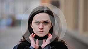 Sensitive portrait of a brunette girl on a cloudy spring day