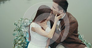 Sensitive portrait of the happy adorable couple in love in stylish vintage cloth floating on the romantic boat decorated