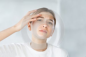 sensitive skin acne problem woman touching face