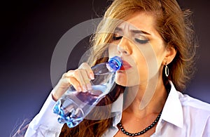 Sensitive teeth woman drinking cold water from bottle. Sudden toothache.