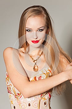 Sensitive young girl in gold cocktail dress