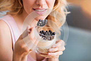 Sensitive young woman eating desert