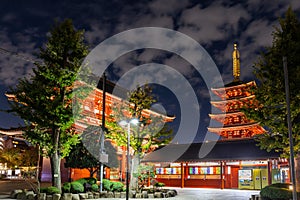 Sensoji Temple in nighttime, symbolized by large red lanterns and 5-story pagoda with light