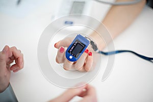 The sensor measuring the pulse and oxygen in the blood on the finger