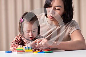 Sensorimotor development of children with down syndrome,cute girl with her mother photo