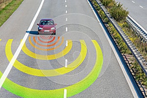 Sensors monitor the traffic in a modern car on a fast road...