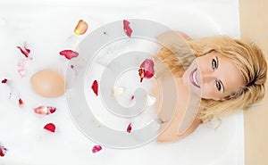 Sensual Alluring Caucasian Blond Female in Foamy Bathtub Filled with Flowery Petals