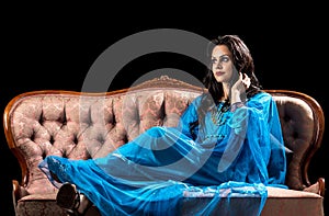 Sensual arabic girl on the retro sofa