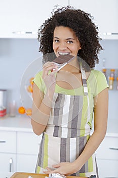 Sensual attractive young woman eating chocolate