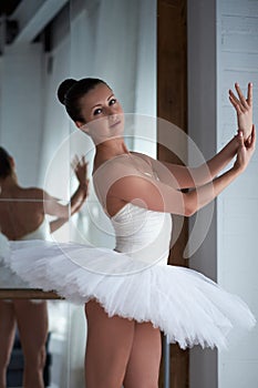 Sensual ballerina posing at barre.