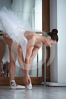 Sensual ballerina posing at barre.