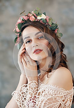 Sensual beautiful woman portrait with wreath of flowers in her hair