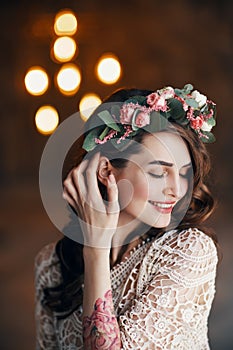 Sensual beautiful woman portrait with wreath of flowers in her hair