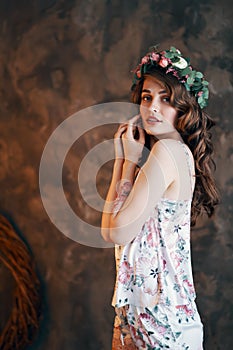 Sensual beautiful woman with wreath of flowers in her hair