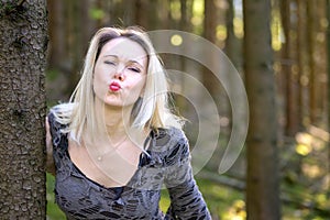 Sensual blond woman pouting her lips for a kiss