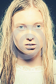 Sensual blond young woman with wet hair look at camera