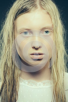 Sensual blond young woman with wet hair look at camera