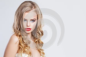 Sensual blonde woman with long healthy curly hair and red lips