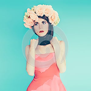 Sensual brunette lady with floral wreath on her head.