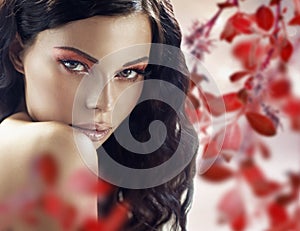 Sensual brunette lady over the petals background photo