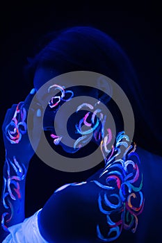 Sensual caucasian girl with fluorescent body art