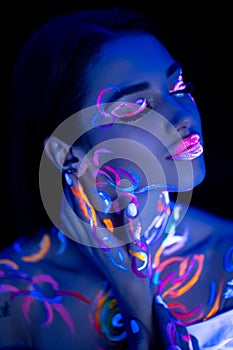 Sensual caucasian girl with fluorescent body art