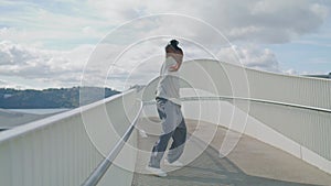 Sensual choreographer perform dance on modern bridge. Man dancing contemporary