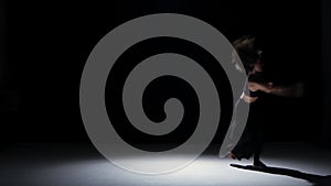 Sensual contemporary dance performance of two dancers on black, shadow