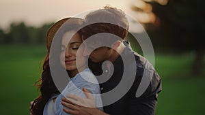 Sensual couple expressing feelings outdoors. Girl and guy spending date in park