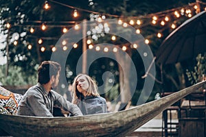 Sensual couple resting on hammock at romantic resort outdoors, summer vacation in the nature concept