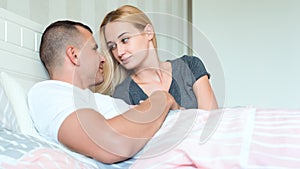 Sensual couple in their bedroom looking lovingly at each other, sex concept photo