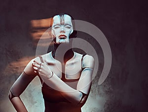 Sensual cyber woman with creative make-up. Technology and future concept. Isolated on a dark textured background.