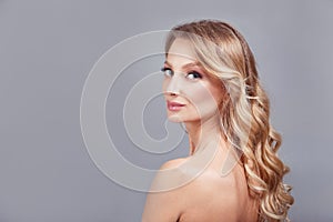 Sensual fashion closeup portrait of young pretty woman blond on gray background.