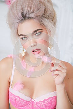 Sensual girl with blond hair in lingerie and accessories