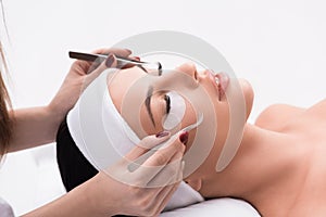 Sensual girl ha having eyelash extension procedure