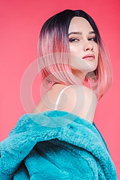 sensual girl with pink hair posing in blue fur coat,