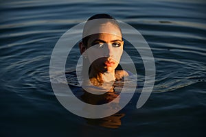 Sensual girl in water. Beauty woman. Fashion portrait. Summer beach.