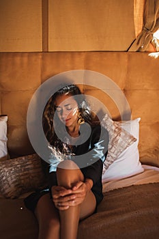 Sensual glamour portrait woman in interior of modern luxury glamping tent camp