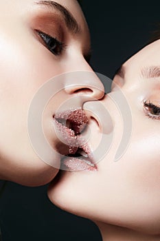 Sensual kiss of Couple Women with sugar on lips