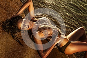 Sensual lady lying on the beach.