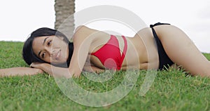 Sensual model posing in bikini on grass