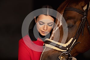 Sensual photo young woman rider and horse, concept of mutual understanding of girl and animal, antistress therapy