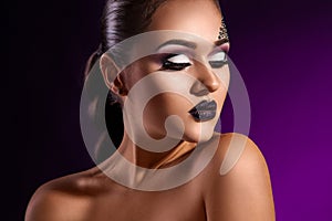 Sensual portrait of elegance adult woman on purple background