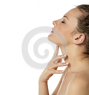 Sensual portrait of a young beautiful shirtless woman with closed eyes touches her neck
